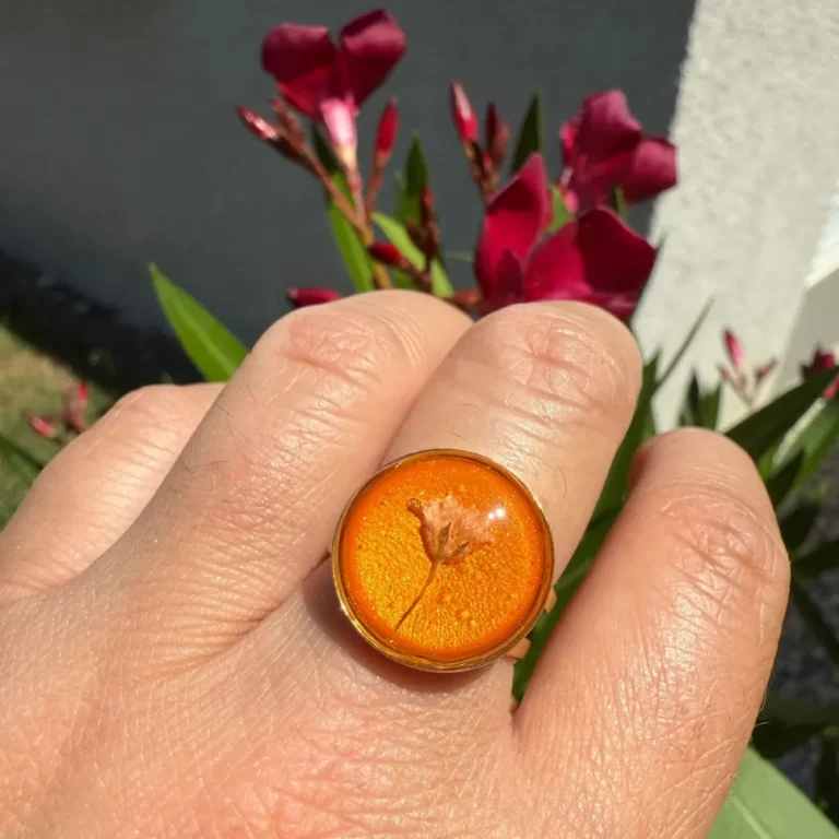 Bague ajustable dorée avec fleur de gypsophile séchée incrustée dans résine orange – bijou floral artisanal L’Atelier d’Emy‑Lys